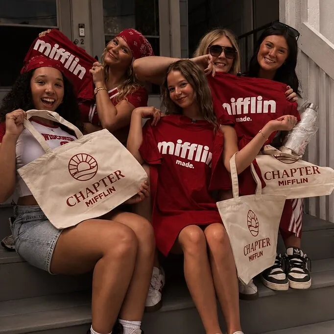 Friends showing off t-shirts